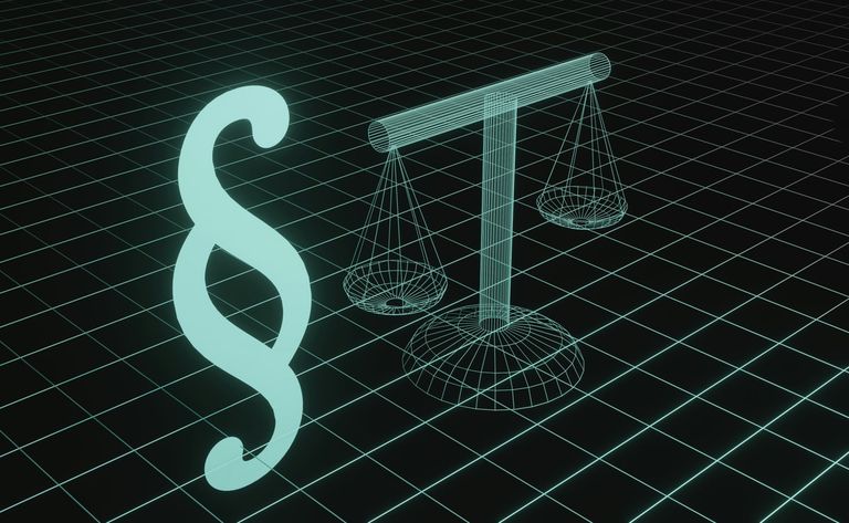 A glowing section sign beside a wireframe set of scales on a dark grid.